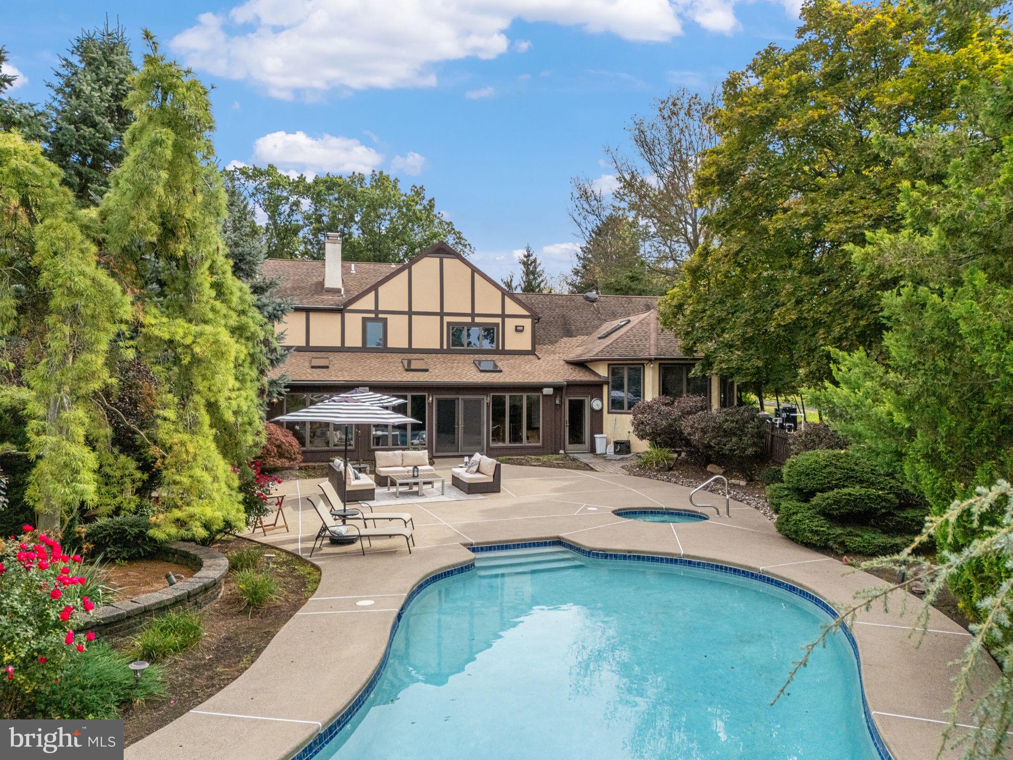 1995 Peppermint Road Coopersburg, PA 18036 - Photo 5 of 67 a view of a patio with couches and a table and chairs with plants and palm trees
