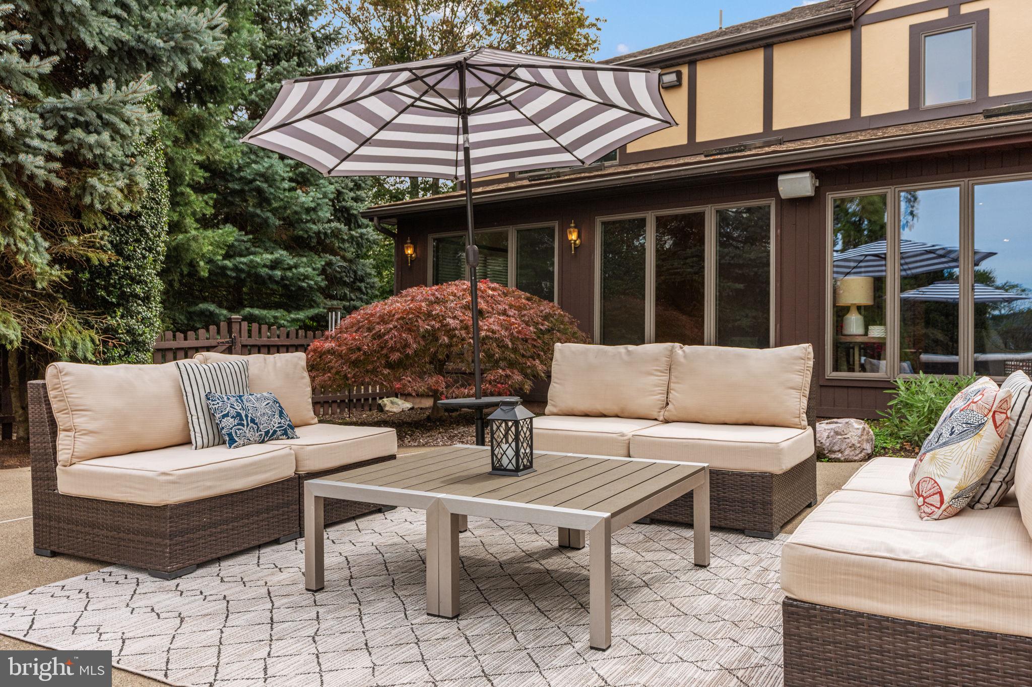 1995 Peppermint Road Coopersburg, PA 18036 - Photo 54 of 67 a view of a patio with couches table and chairs under an umbrella