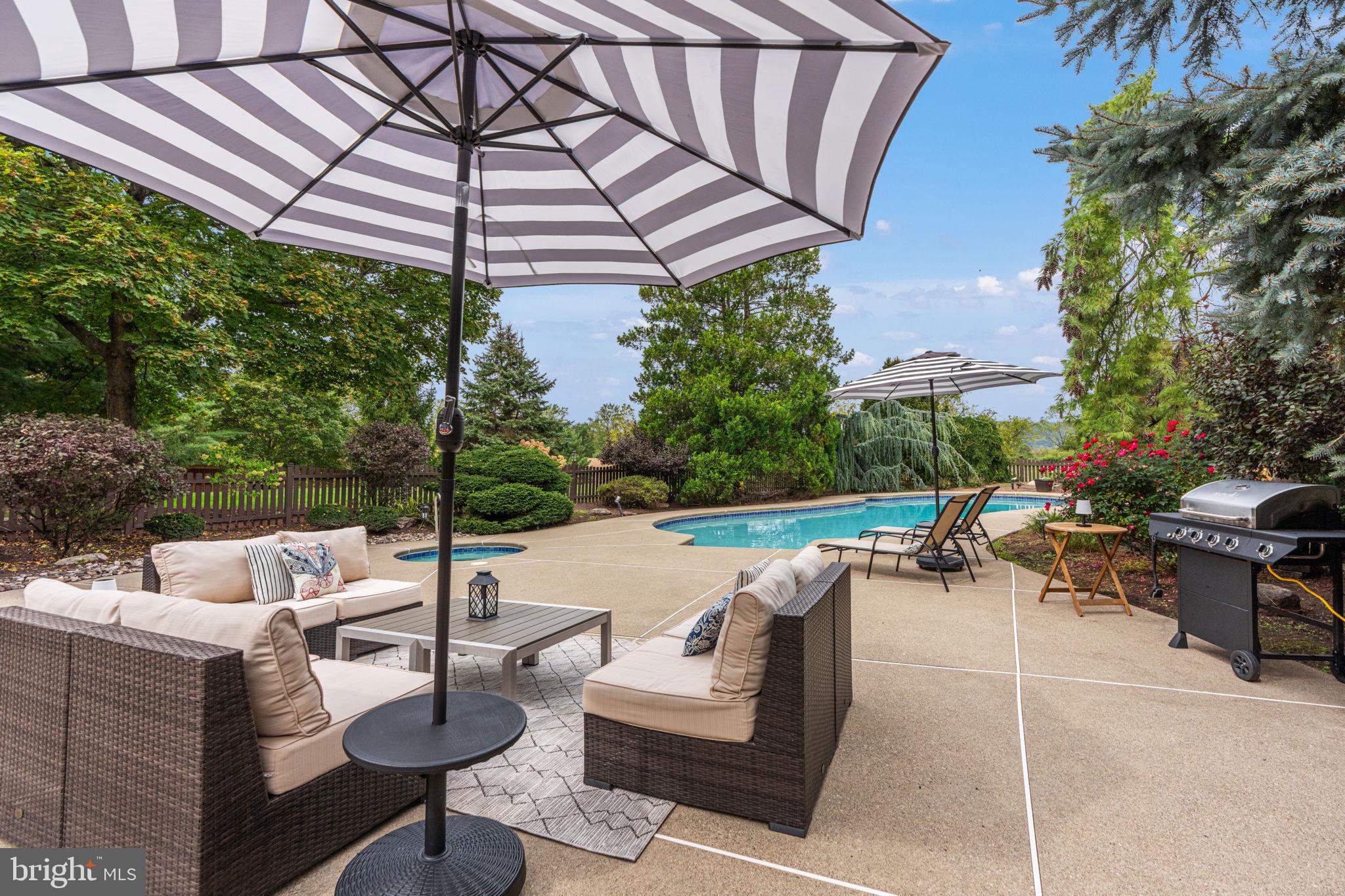 1995 Peppermint Road Coopersburg, PA 18036 - Photo 55 of 67 a view of a patio with couches and chairs under an umbrella