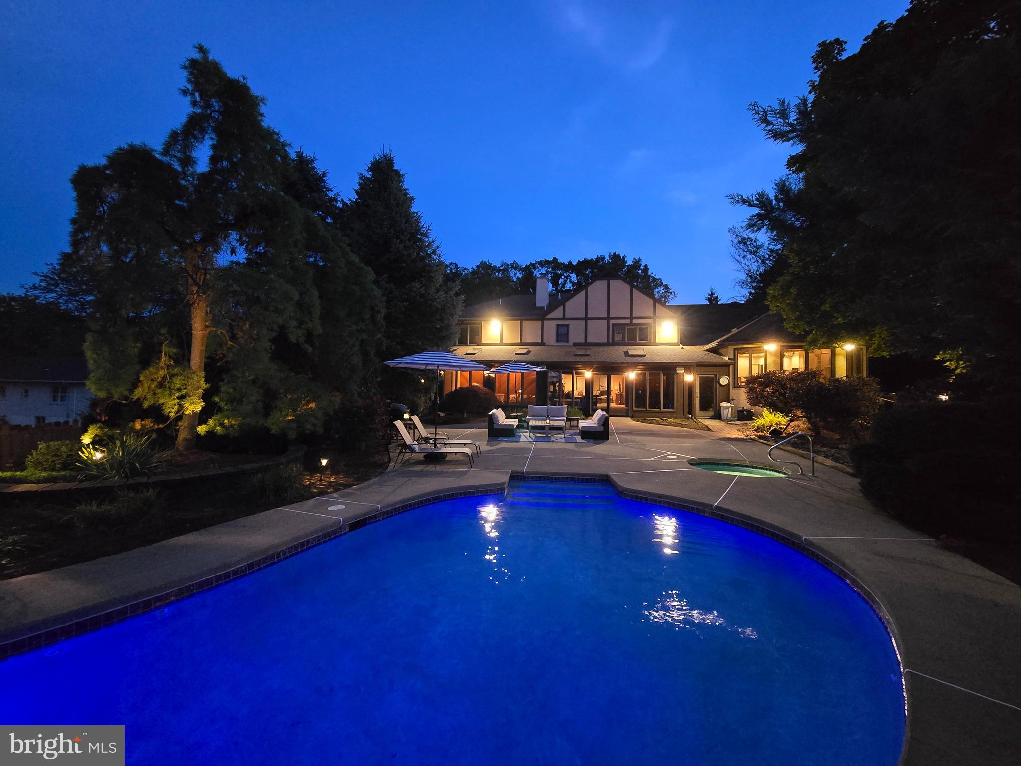 1995 Peppermint Road Coopersburg, PA 18036 - Photo 59 of 67 a view of a swimming pool with lawn chairs and a fire pit with potted plants
