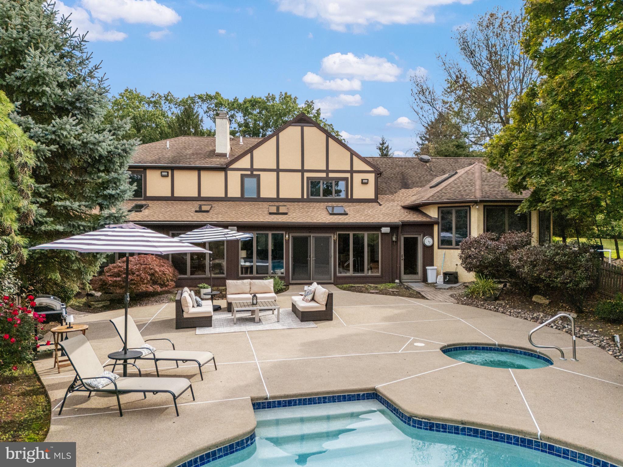 1995 Peppermint Road Coopersburg, PA 18036 - Photo 6 of 67 a view of a white house with table and chairs under an umbrella