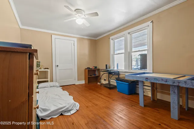a living room with furniture a window and wooden floor