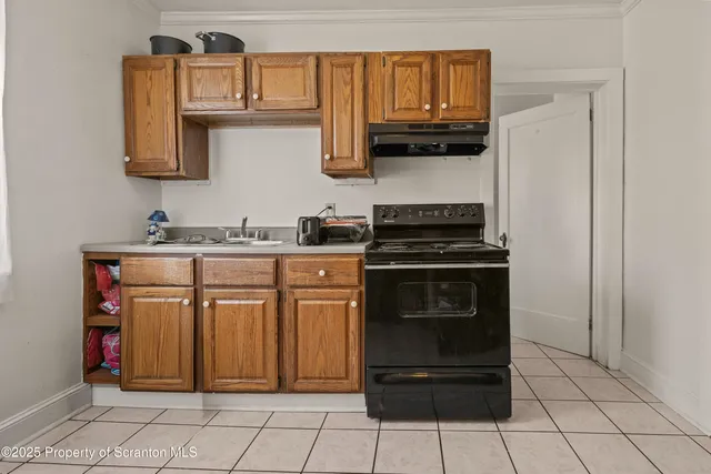 a kitchen with a sink a stove and cabinets