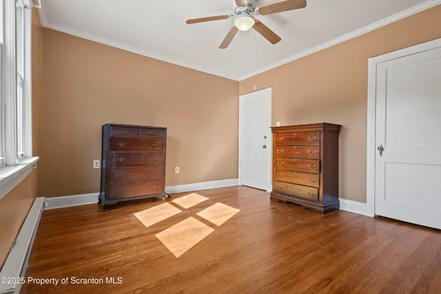 an empty room with wooden floor and closet