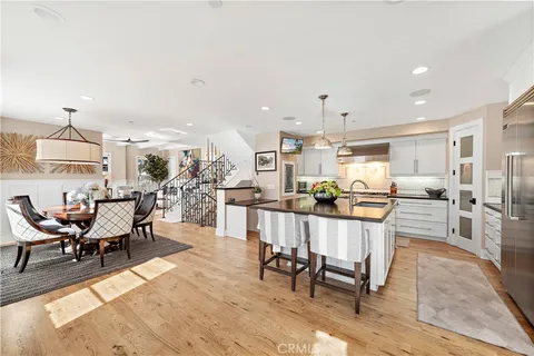 a living room with furniture a table and kitchen view
