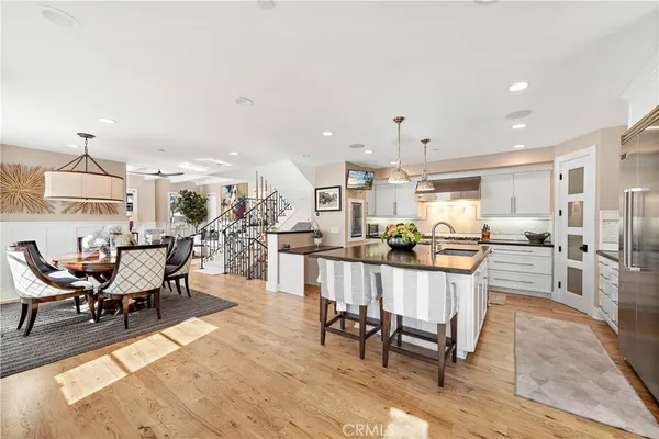 a living room with furniture a table and kitchen view