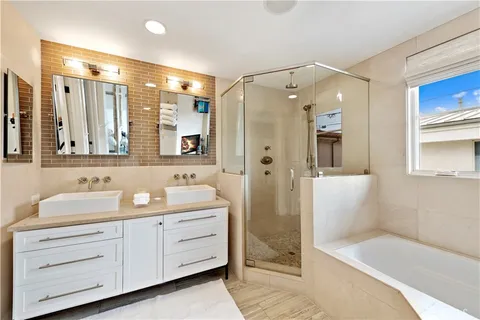 a bathroom with a double vanity sink mirror double shower and bathtub