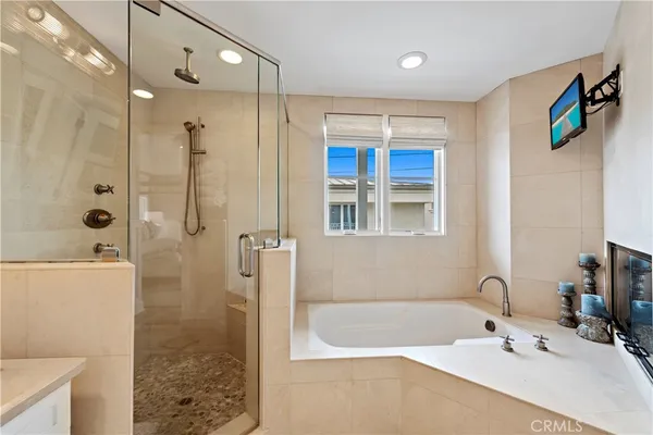 a bathroom with a tub a sink and mirror