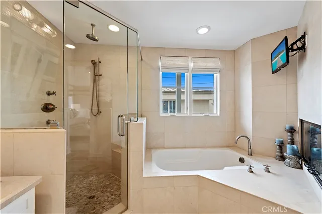 a bathroom with a tub a sink and mirror