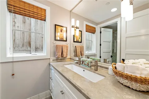 a en suite bathroom with a double vanity sink and a window