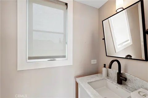 a bathroom with a sink and mirror