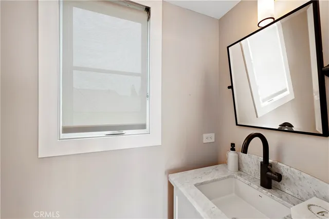 a bathroom with a sink and mirror