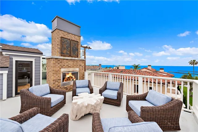 a roof deck with couches and potted plants