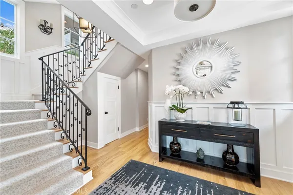 a living room with stairs and a wooden floor
