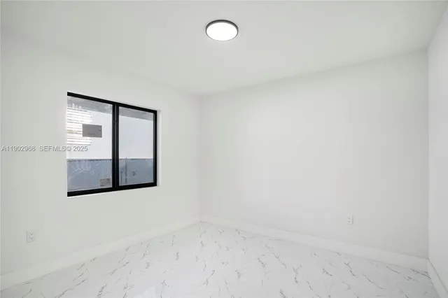 an empty room with windows and closet