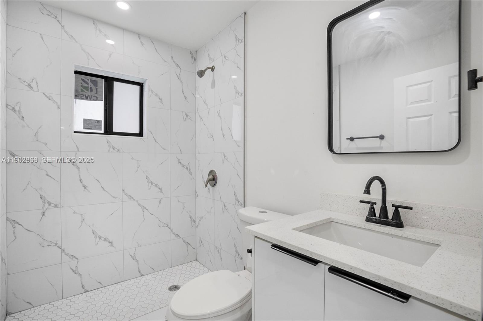 10362 Southwest 180th Street Miami, FL 33157 - Photo 12 of 18 a bathroom with a toilet sink and mirror