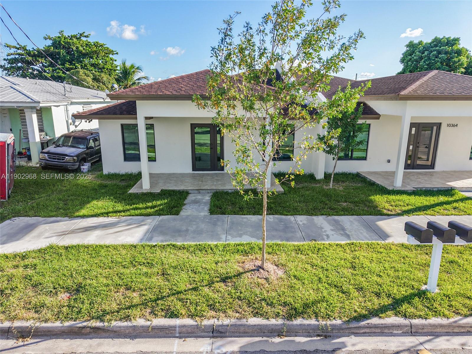 10362 Southwest 180th Street Miami, FL 33157 - Photo 14 of 18 a front view of a house with garden