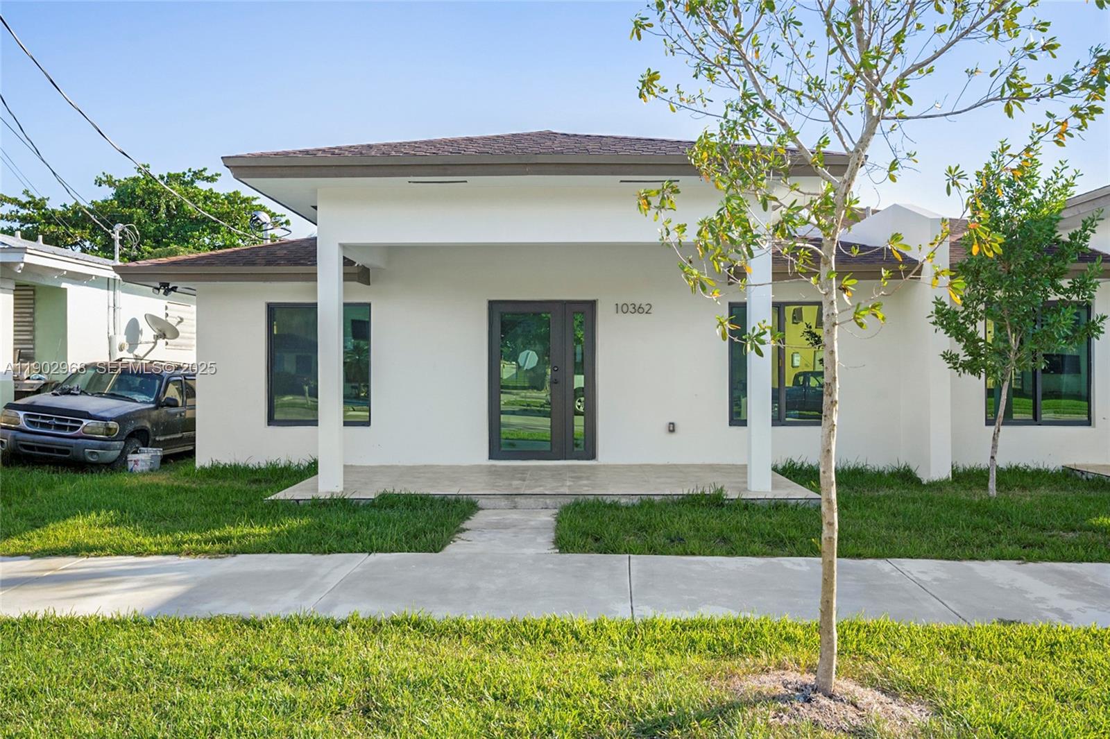 10362 Southwest 180th Street Miami, FL 33157 - Photo 2 of 18 a front view of a house with a garden and plants