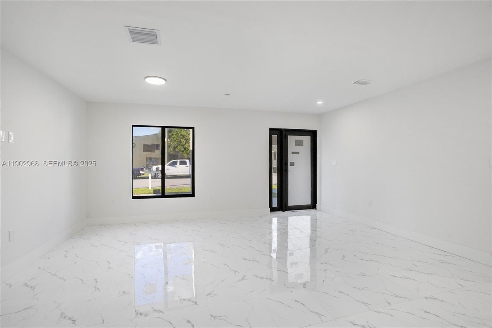 10362 Southwest 180th Street Miami, FL 33157 - Photo 6 of 18 an empty room with windows and cabinet