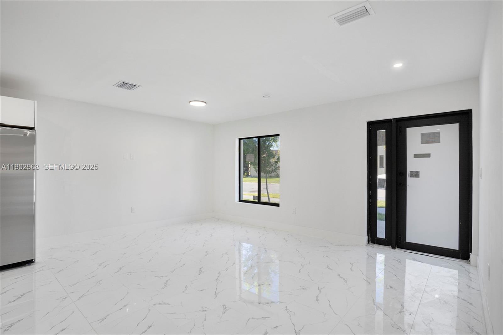 10362 Southwest 180th Street Miami, FL 33157 - Photo 7 of 18 a view of an empty room with a window