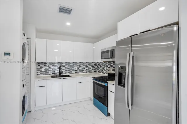 a kitchen with stainless steel appliances a refrigerator and a stove