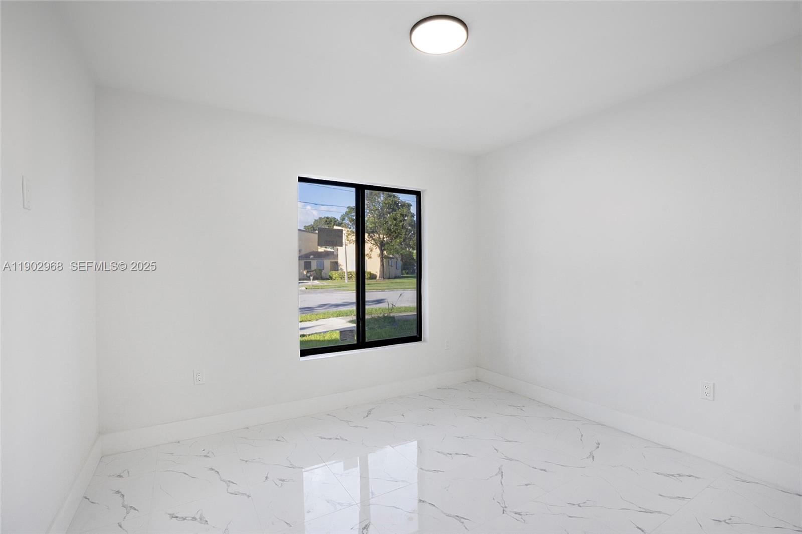 10362 Southwest 180th Street Miami, FL 33157 - Photo 10 of 18 an empty room with windows