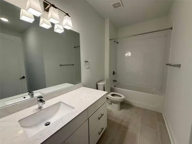 a large kitchen with a wooden floor and stainless steel appliances