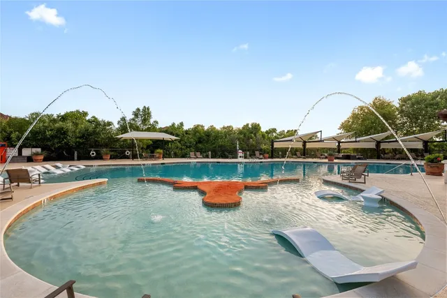 swimming pool view with a lake view