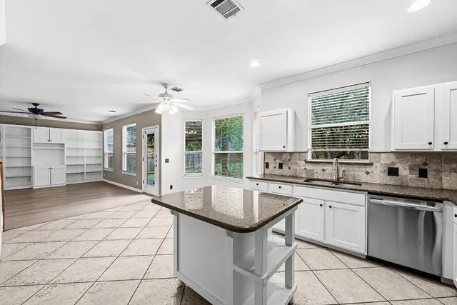 a kitchen with sink cabinets and window