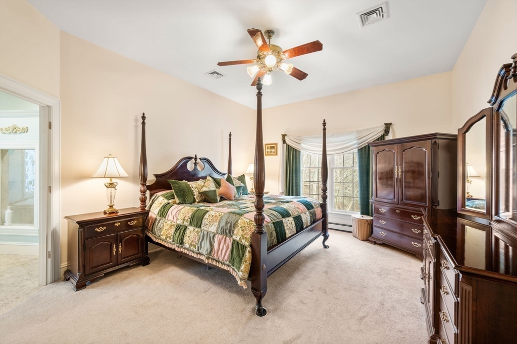 332 Division Road Dartmouth, MA 02748 - Photo 13 of 42 a spacious bedroom with a bed and a chandelier