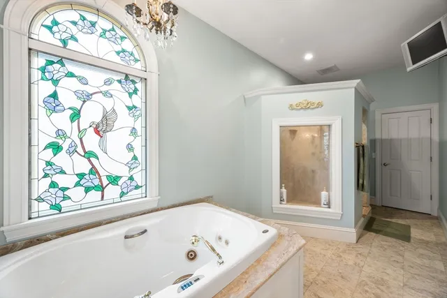 a bathroom with a tub and a window