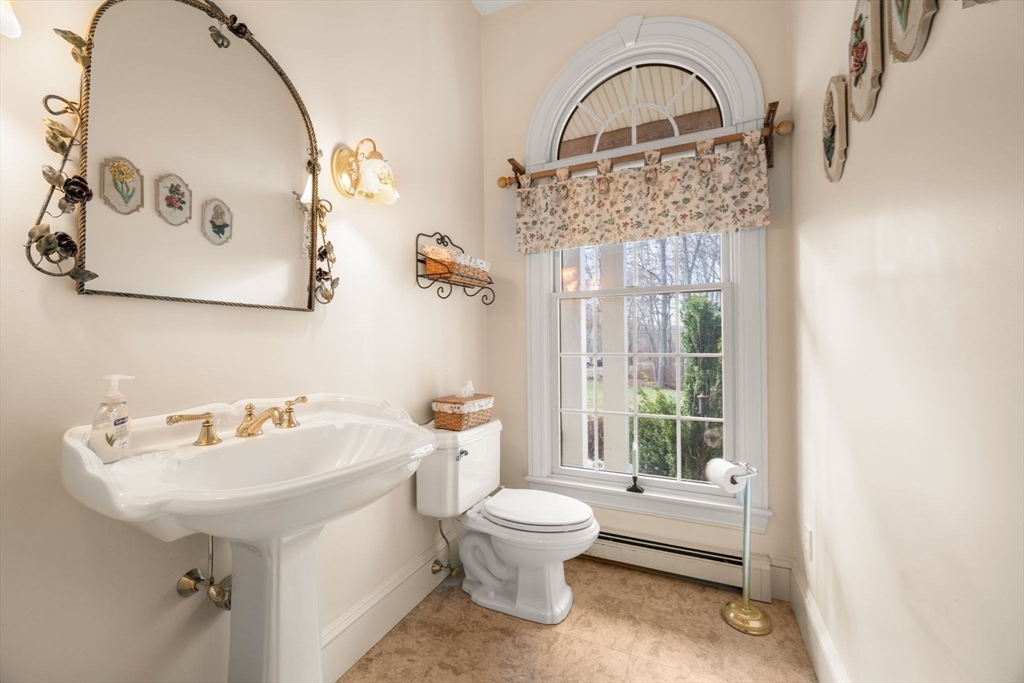 332 Division Road Dartmouth, MA 02748 - Photo 17 of 42 a bathroom with a sink a toilet and a mirror