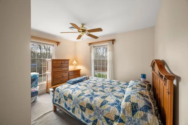 a bedroom with a bed dresser and a window