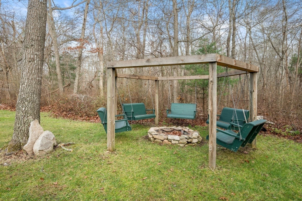 332 Division Road Dartmouth, MA 02748 - Photo 35 of 42 a backyard of a house with sofas fire pit and couches