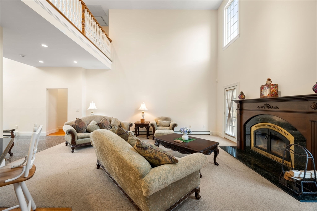 332 Division Road Dartmouth, MA 02748 - Photo 4 of 42 a living room with furniture and a fireplace