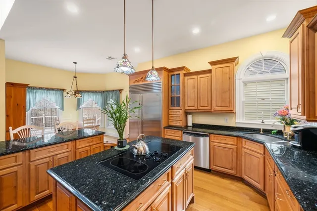 a kitchen with stainless steel appliances granite countertop sink stove and cabinets