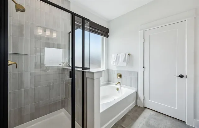 a bathroom with a bathtub and a shower
