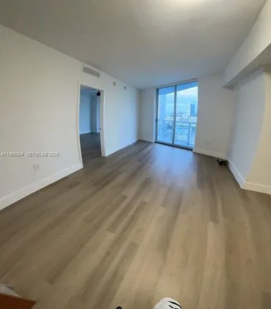 a view of a hardwood floor and a sink in a room