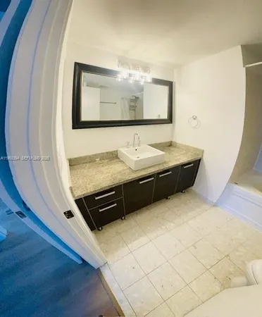 a bathroom with a mirror and a shower