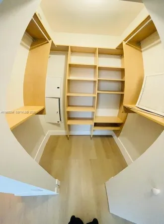 a white toilet sitting next to a white sink