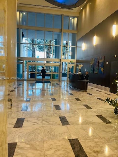 185 Southwest 7th Street, Unit 1605 Miami, FL 33130 - Photo 4 of 22 a lobby with glass door and glass door