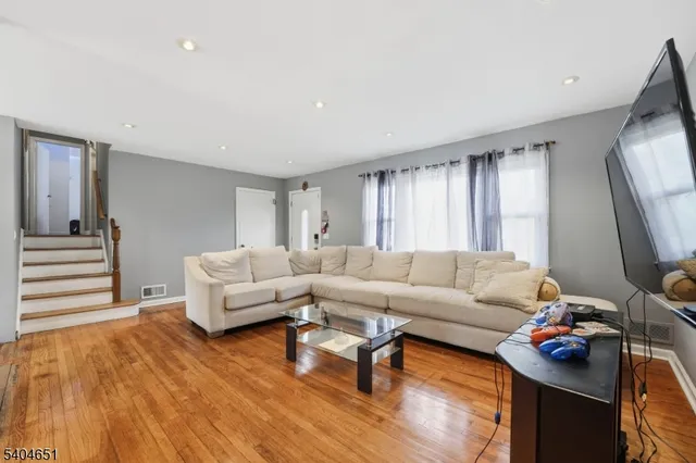 a living room with furniture a couch and a flat screen tv