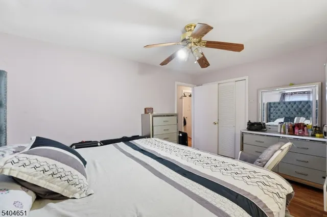 a bedroom with a bed and a mirror