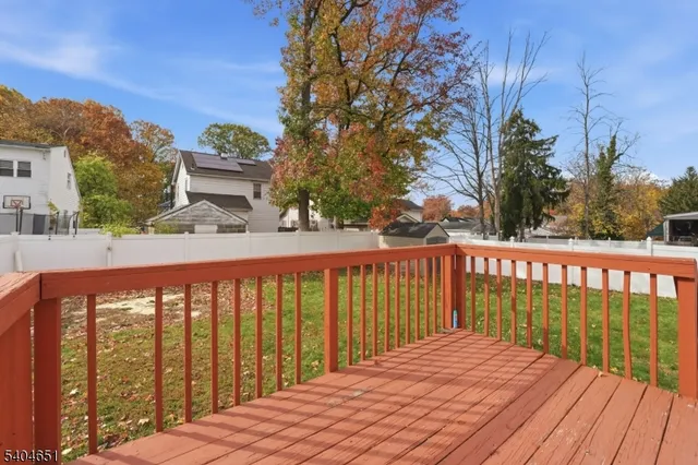 a view of a balcony with wooden floor and fence