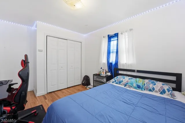 a bedroom with bed and a closet