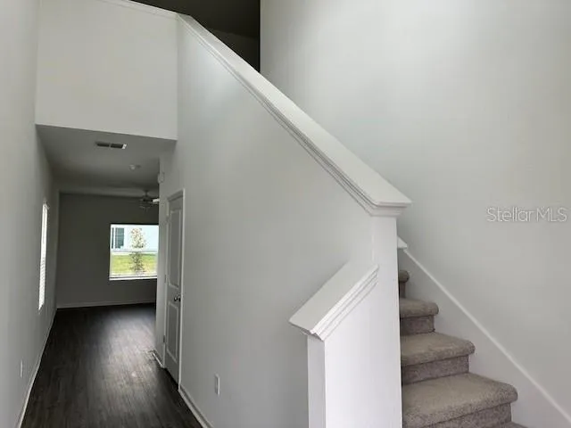 a view of entryway and hall with wooden floor
