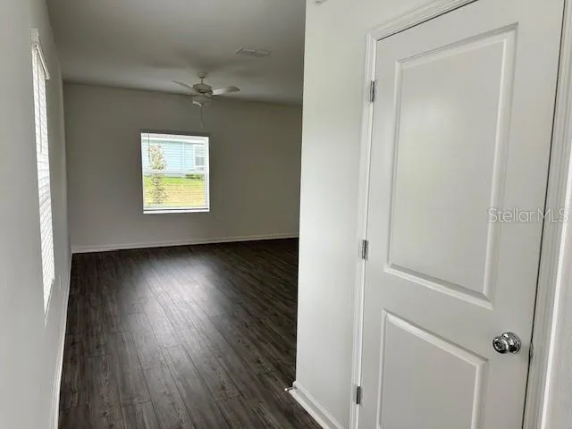 a view of a livingroom with wooden floor and a window