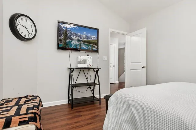 a bedroom with a bed and a wall painting