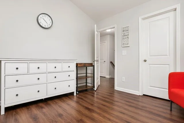 a view of a room with wooden floor