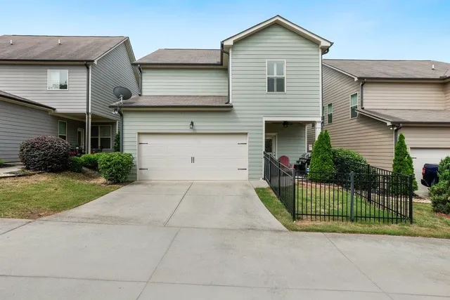 a front view of a house with a garden and plants